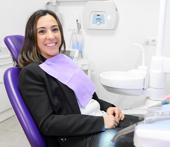 Patient smiling while sitting in treatment chair